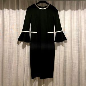 Black fitted knee length dress with white details